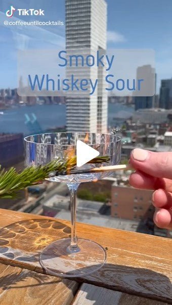 city hand match flame cocktail glass rosemary plant stem