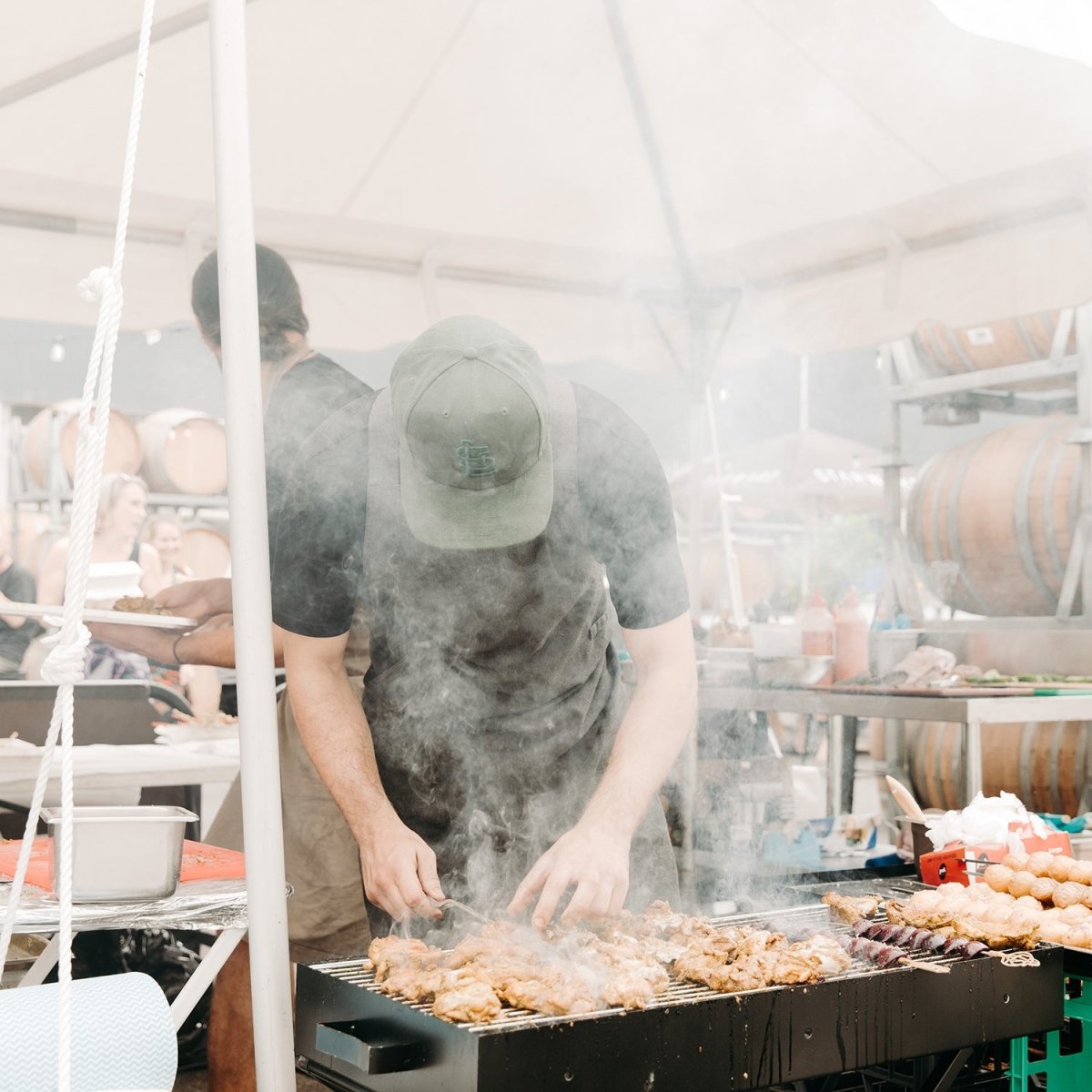 meat smoke grill barbecue bright umbrella outside cooking man chef hands searing sauce food red brown