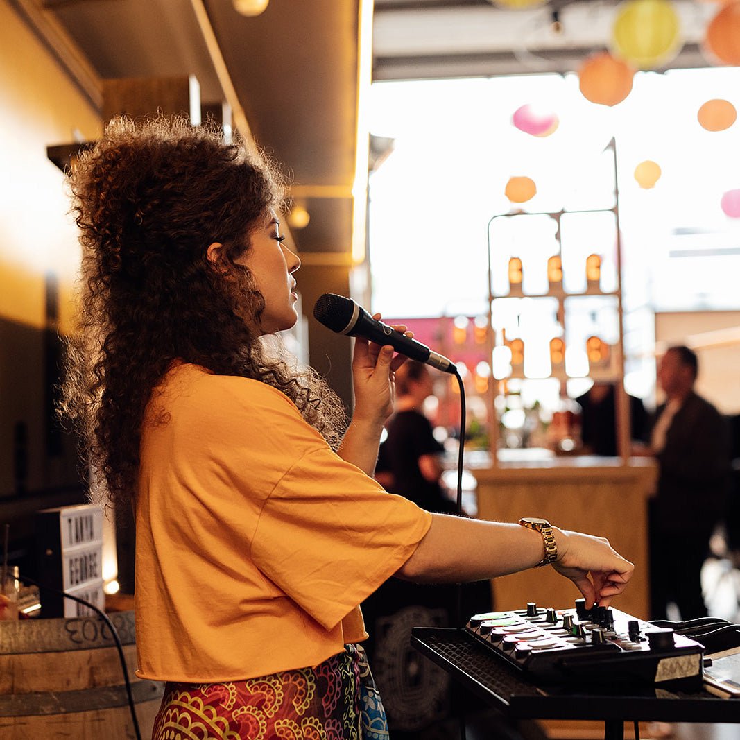 woman singing microphone day yellow bright party event distillery