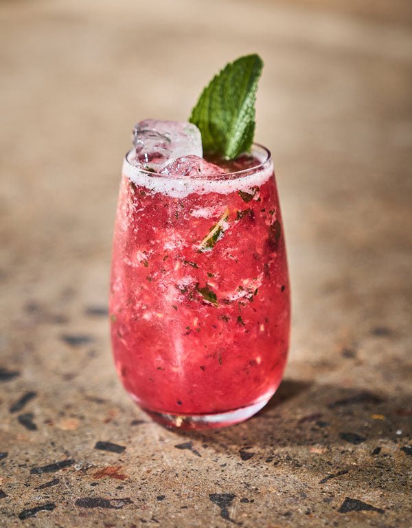 cocktail glass liquids pink red wooden table green leaf ice drink