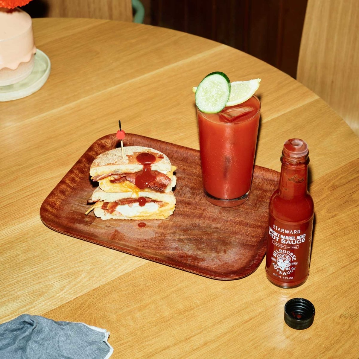 glass liquids red gold hot sauce bottle wooden table food cocktail