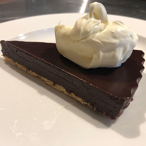 chocolate dessert cake slice tart cream white dark brown plate