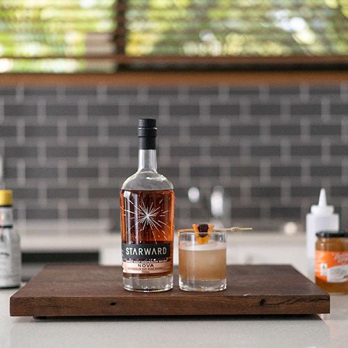 kitchen tiles grey glass whisky bottle cocktails liquids dark brown gold garnish fruit glass jar jam orange black lid