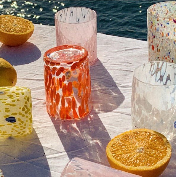 glasses table orange white yellow pink sunlight